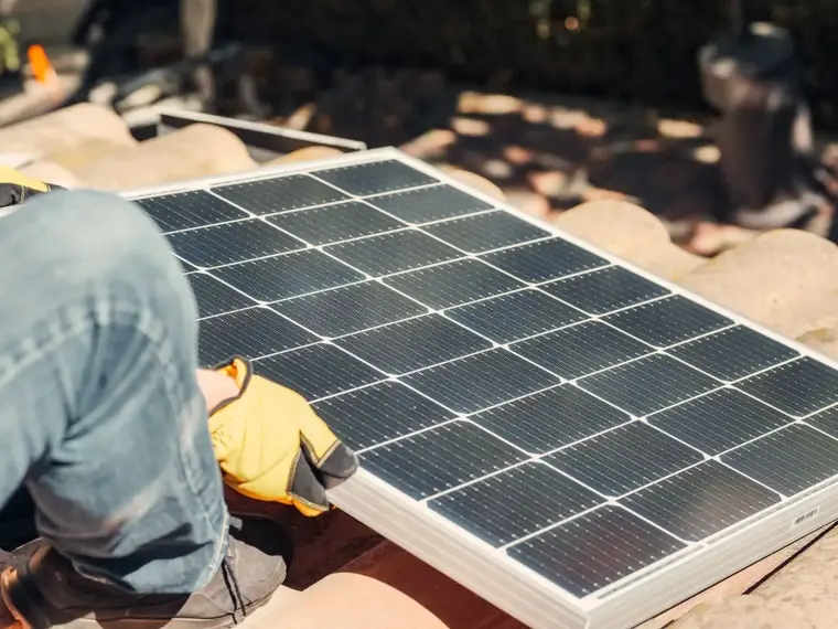 Solar panels on a roof under a clear sky
